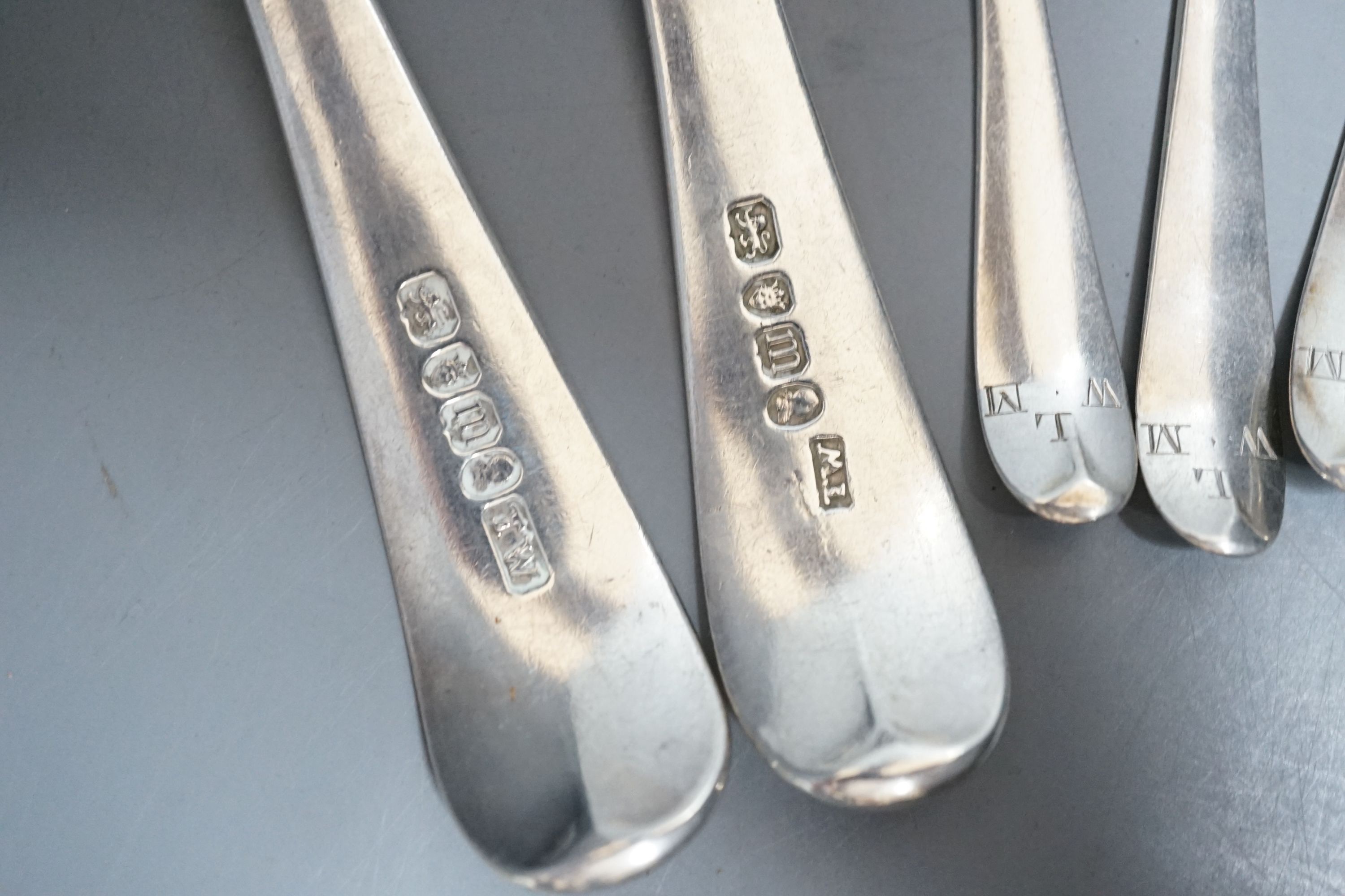 A set of silver George III bright cut engraved silver Old English pattern teaspoons, by Hester Bateman, no date letter and a pair of George III silver bright cut engraved Old English tablespoons, London, 1787